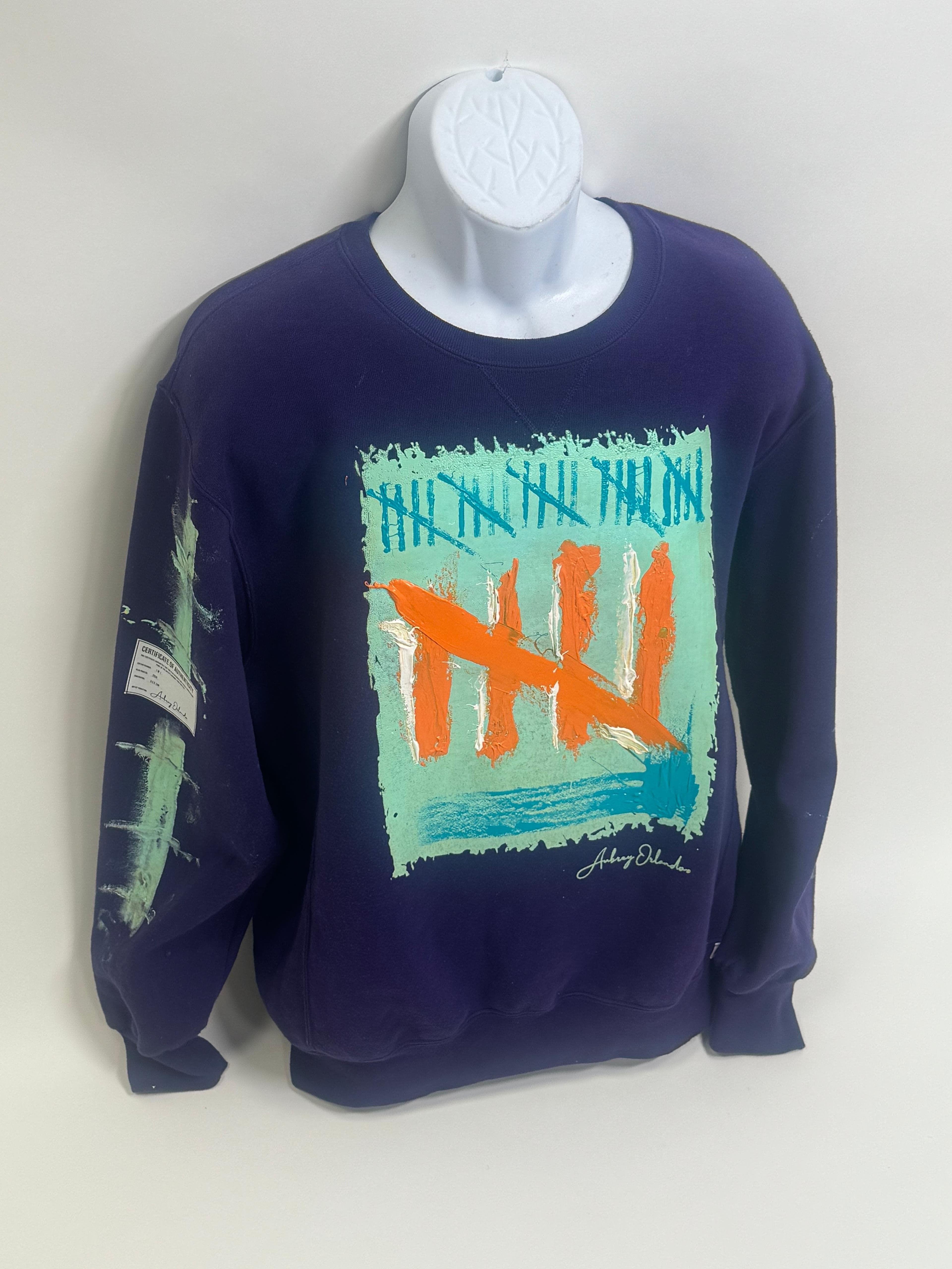 Navy crewneck with hand-painted teal and orange tally-mark patch