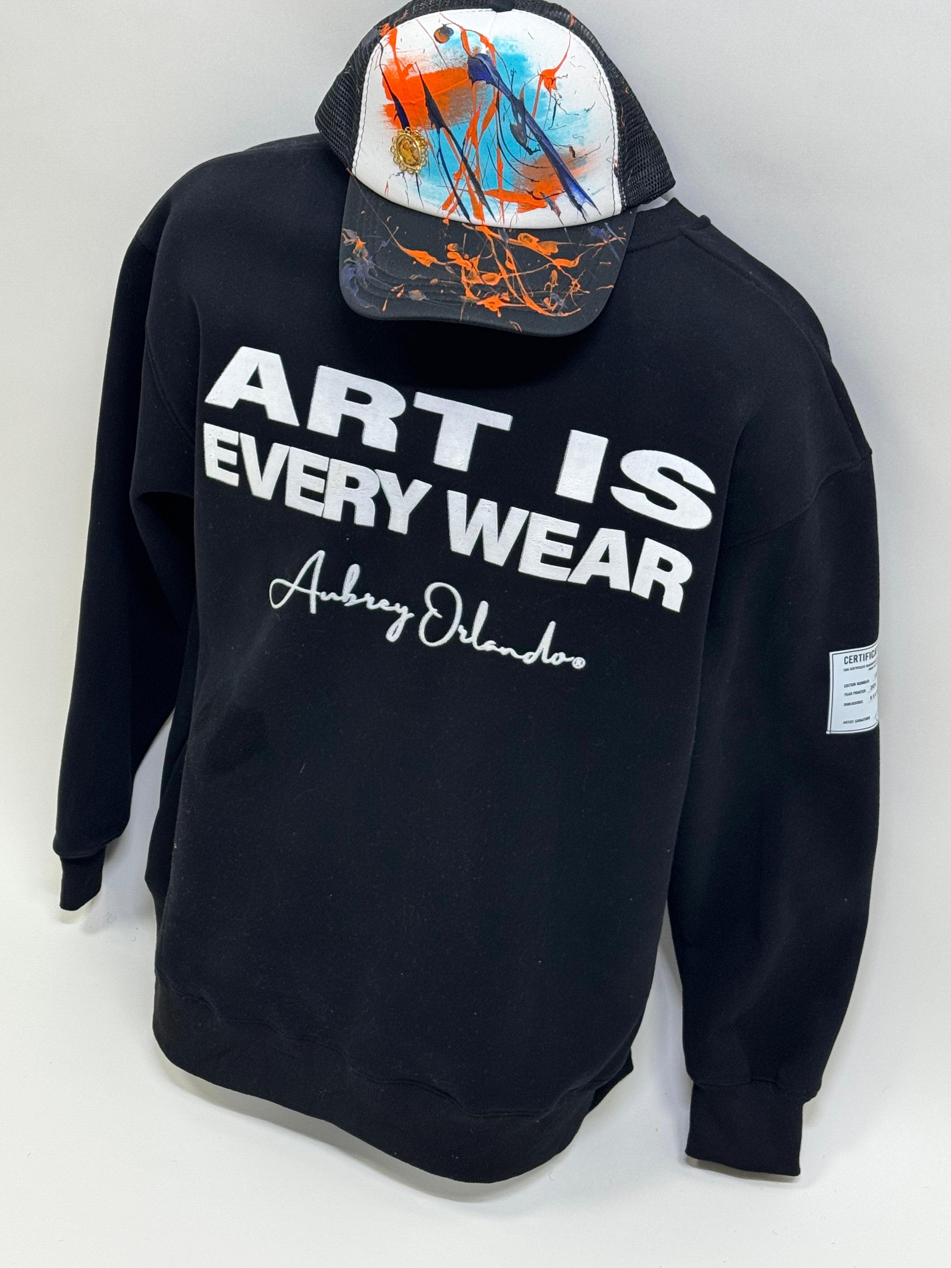 Black crewneck reading ART IS EVERY WEAR with Aubrey Orlando script signature